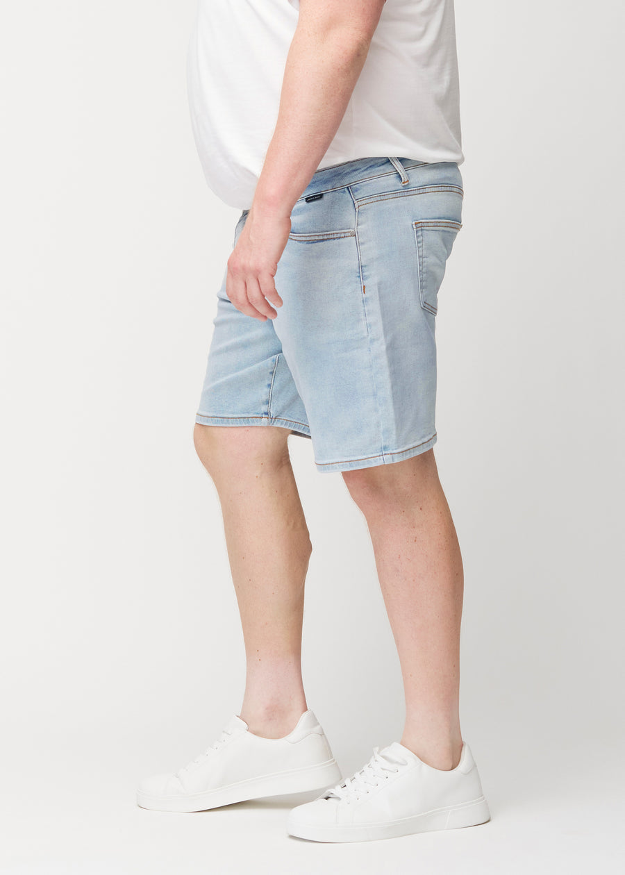 Light blue denim shorts for men in the colour Waves with a regular fit seen from the side on a plus-size model.