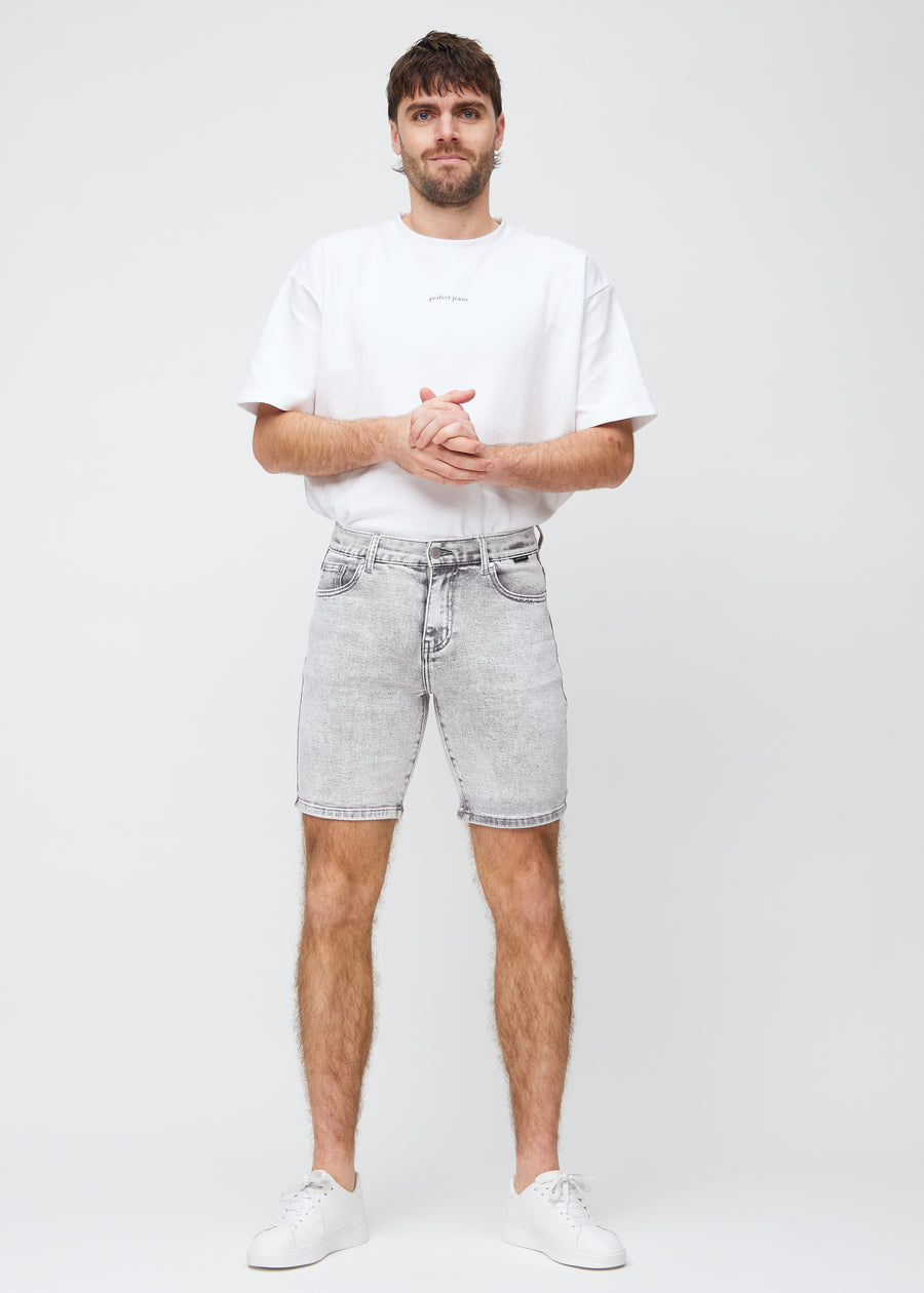 Full image of model in light grey denim middle-slim shorts.