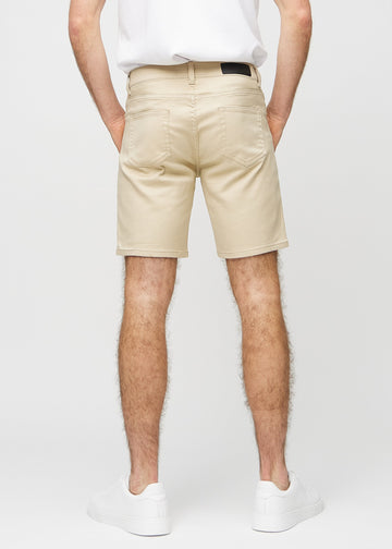 Beige middle-slim shorts seen from the back, so the entire product can be seen.